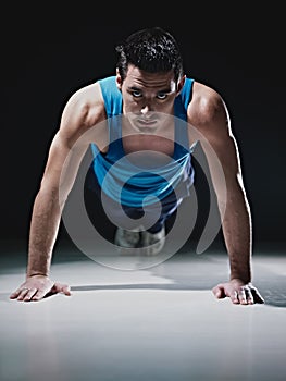 Man doing push-ups on black background