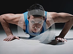 Man doing push-ups on black background