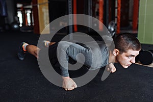 A man doing push-UPS in the gym, sports, push-UPS on weights