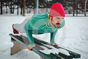 Man doing push ups outside on a snowy day