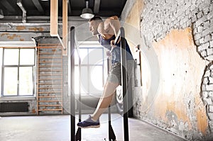 Man doing push-ups on parallel bars in gym