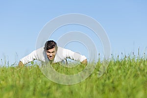 Man doing push ups in summer grass