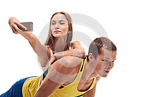 Man doing push ups and woman selfie