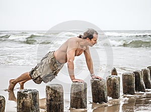 Man doing pushups on the beach