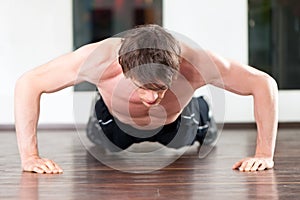 Man doing pushups in gym