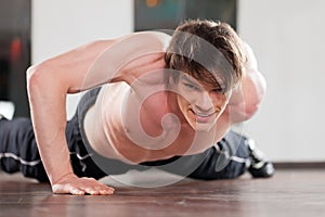Man doing pushups in gym
