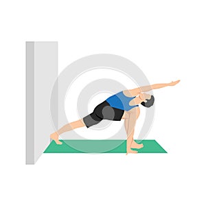 Man doing Revolved side angle pose parivrtta parsvakonasana to the wall