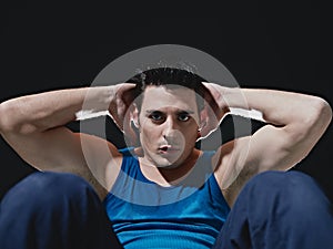 Man doing series of sit-ups on black background