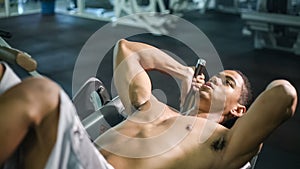 Man doing sit ups fitness exercise at gym