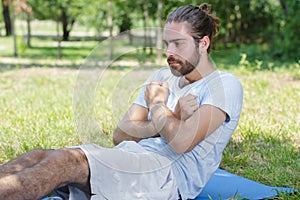 Man doing sit-ups in forest