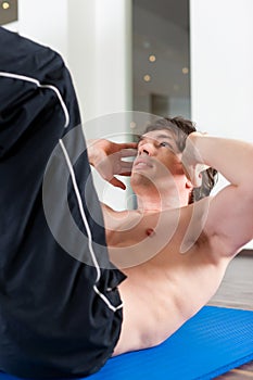 Man doing sit ups in gym