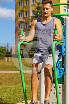 Man doing sit ups in outdoor gym