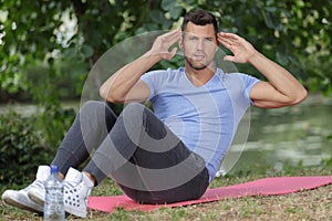 Man doing sit ups outdoors