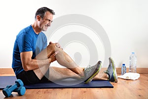 Man doing sport indoors complaining with knee pain