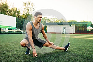 Man doing stretching exercise on outdoor workout