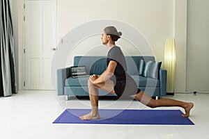 Man doing stretching exercises on a mat