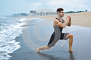 Man Doing Stretching Workout Exercises, Exercising At Beach. Fit