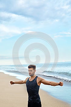 Man Doing Stretching Workout Exercises, Exercising At Beach. Fitness