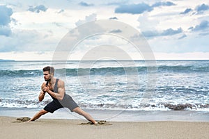 Man Doing Stretching Workout Exercises, Exercising At Beach. Fitness