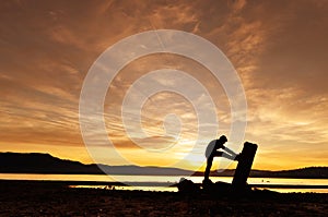 Man doing stretchings at the sunset