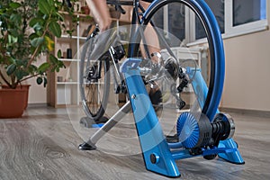 Man doing training on a cycle trainer at home