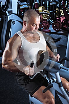 Man doing workout with pull-down machine