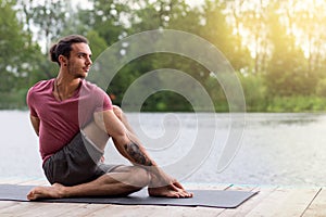 Man doing yoga exercise in the morning. Copy space
