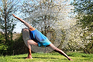 A man doing a Yoga exercise outdoors