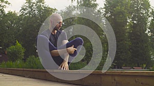A man doing yoga exercises in the park