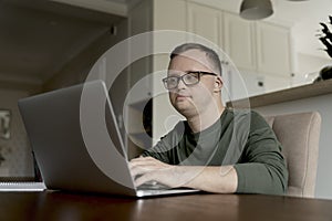 Man with down syndrome larning at home photo