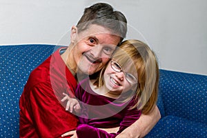 Man With Downs Syndrome Hugs His Great Niece Both Smiling photo