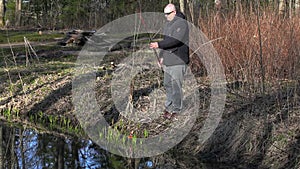 Man draw up fishing rod near river