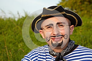 Man with drawed beard and whiskers in pirate suit