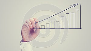 Man drawing an ascending bar graph