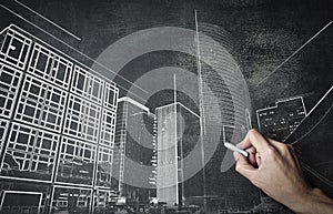 Man drawing buildings on a backboard