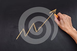 Man drawing yellow arrow showing upward trend and increasing pro