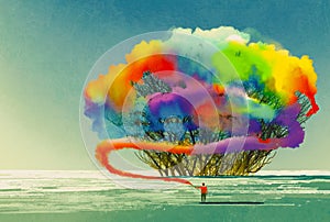 Man draws abstract tree with colorful smoke flare photo