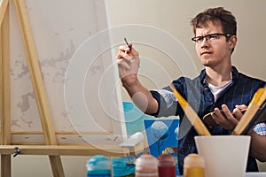 The man draws a picture.