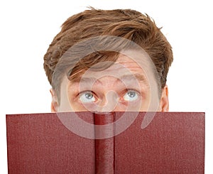 Man dreamily reading book - close-up of eyes