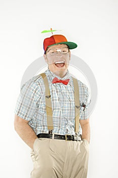 Man dressed as nerd with hands in pockets.