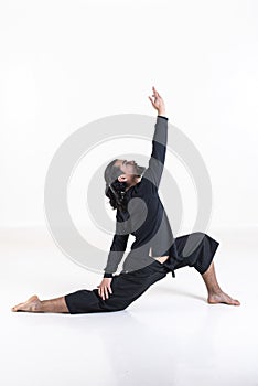 A man dressed in black doing yoga over white background. .anjaneyasana yoga pose
