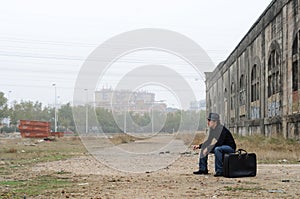 Man dressed in black sitting smoking photo