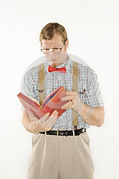 Man dressed like nerd reading.