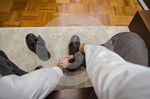 Man dressing tying his shoe laces