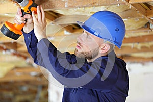 man with drill on building site