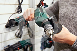 Man with drill in hardware store