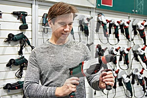 Man with drill in hardware store