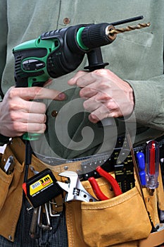 Man with drill and tool belt photo
