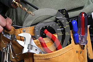 Man with drill and tool belt photo