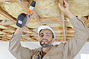 man drilling ceiling